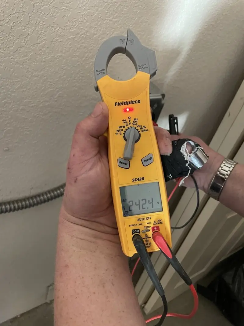 Voltage testing with clamp meter during Whole House Surge Protector in Foley